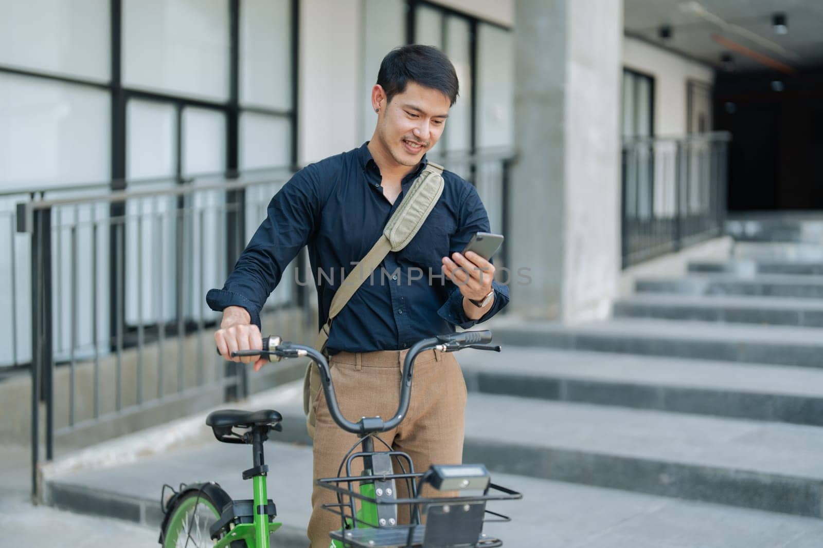 asian young businessman use smart phone while commuting in city. Eco friendly by itchaznong