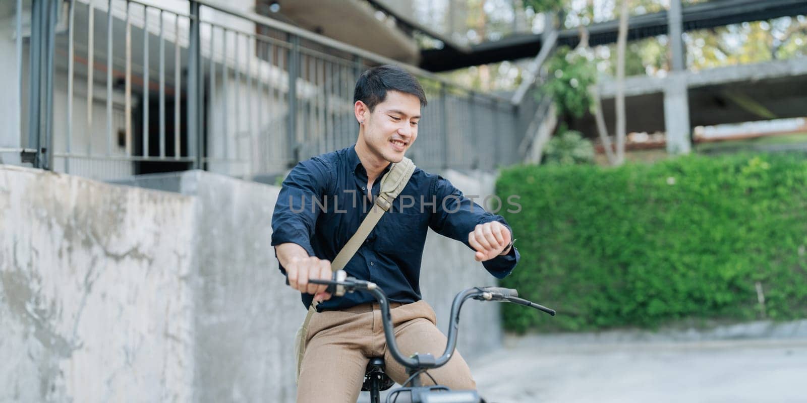 Young businessman in suit in city bike to work eco friendly alternative vehicle green energy.