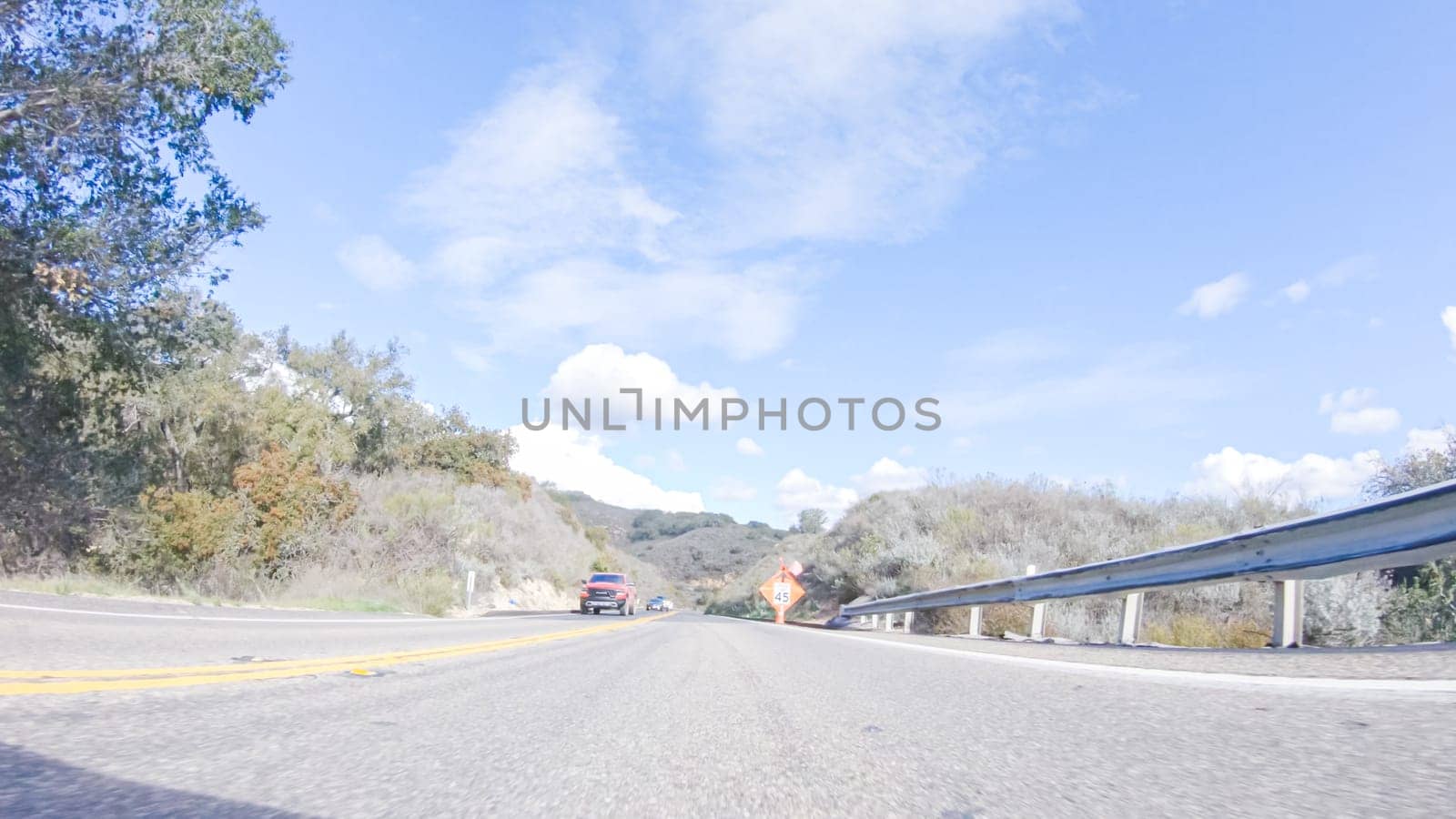 Santa Maria, California, USA-December 6, 2022-Vehicle is cruising along the Cuyama Highway under the bright sun. The surrounding landscape is illuminated by the radiant sunshine, creating a picturesque and inviting scene as the car travels through this captivating area.