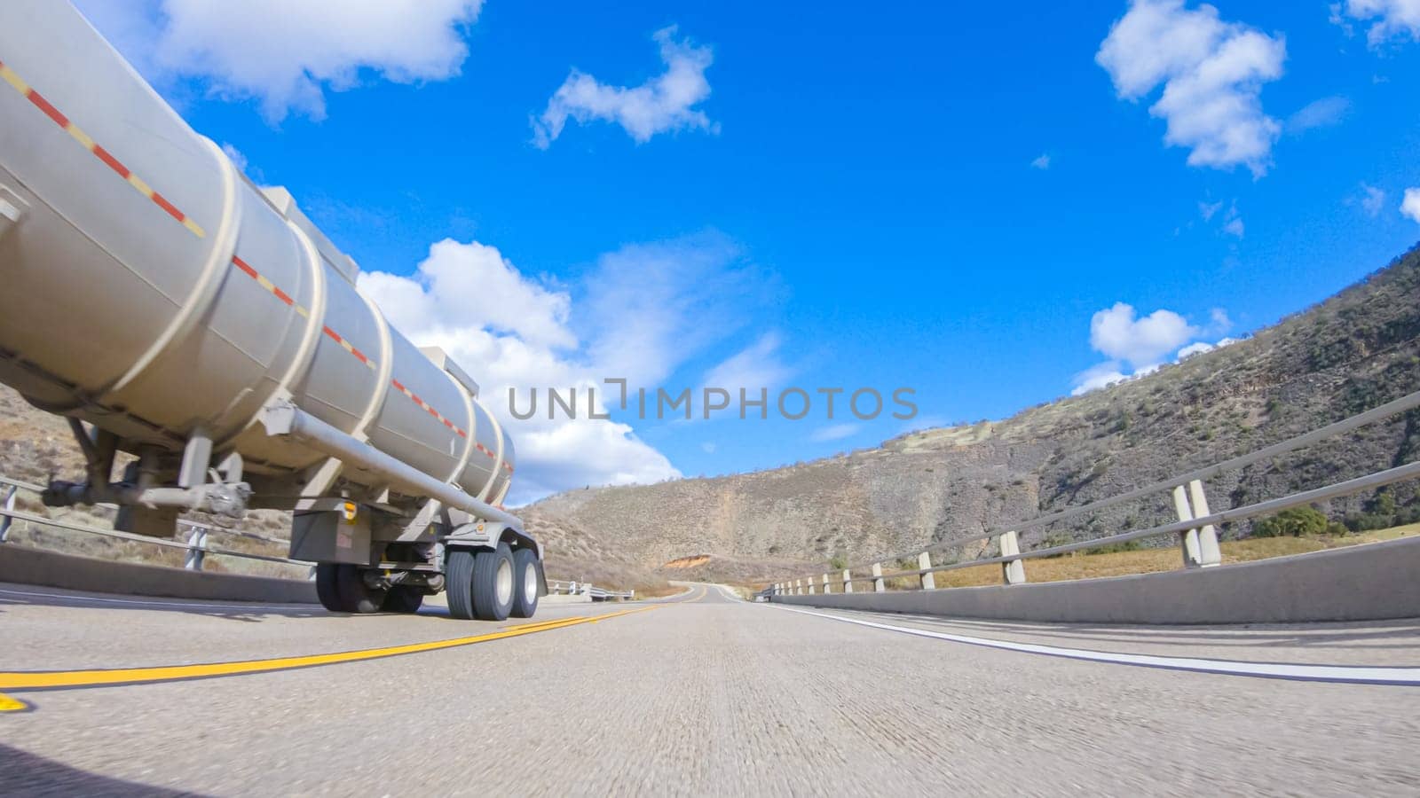 Santa Maria, California, USA-December 6, 2022-Vehicle is cruising along the Cuyama Highway under the bright sun. The surrounding landscape is illuminated by the radiant sunshine, creating a picturesque and inviting scene as the car travels through this captivating area.