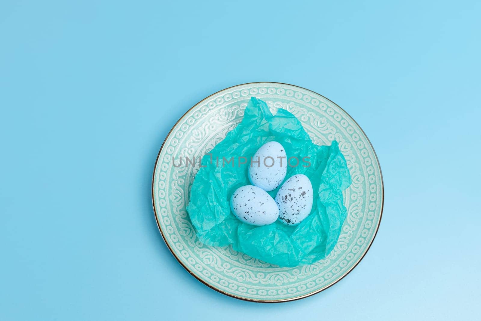 Nest with Easter eggs on the blue background. by mvg6894
