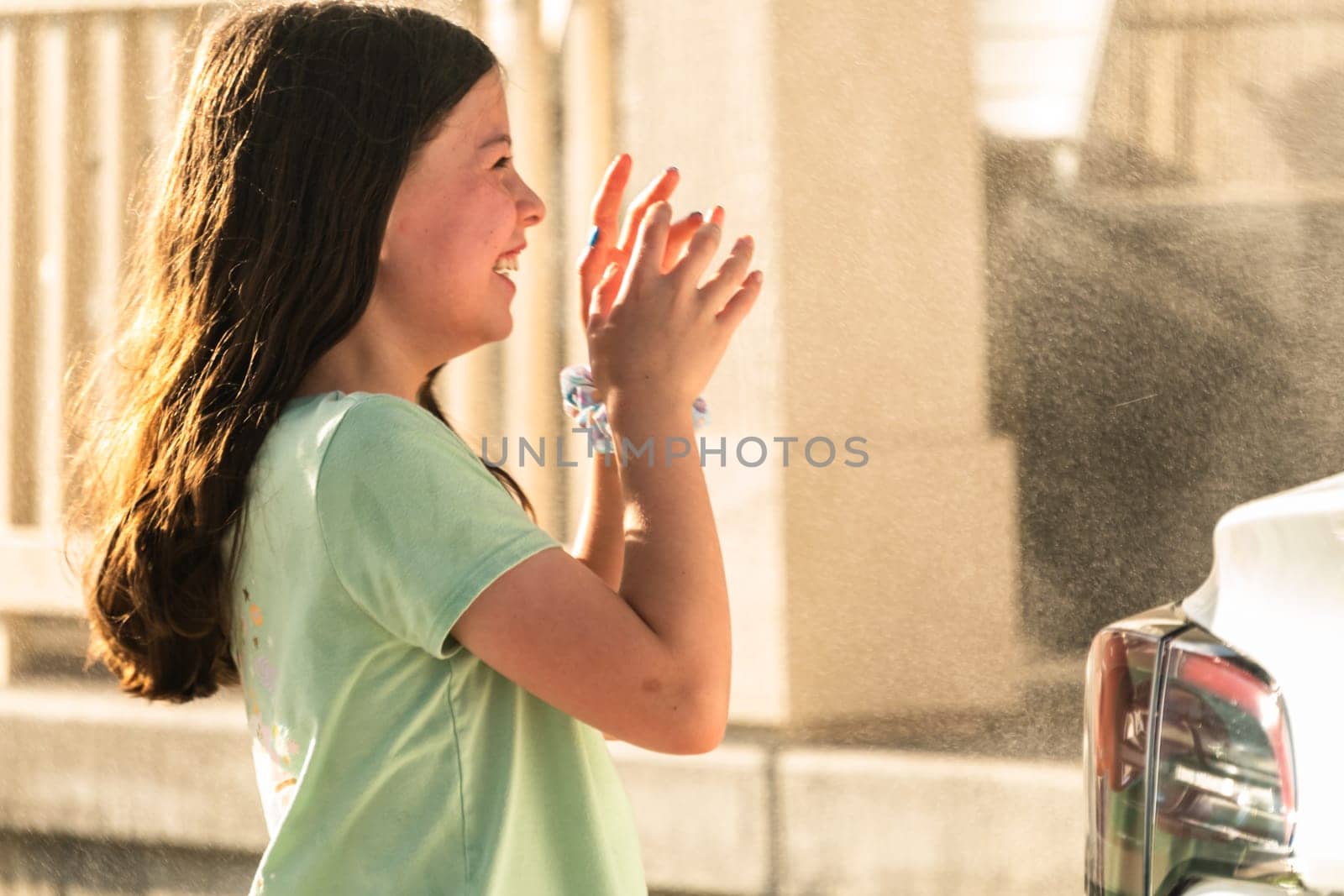 Little Girl Enjoying Water Mist on a Summer Day by arinahabich