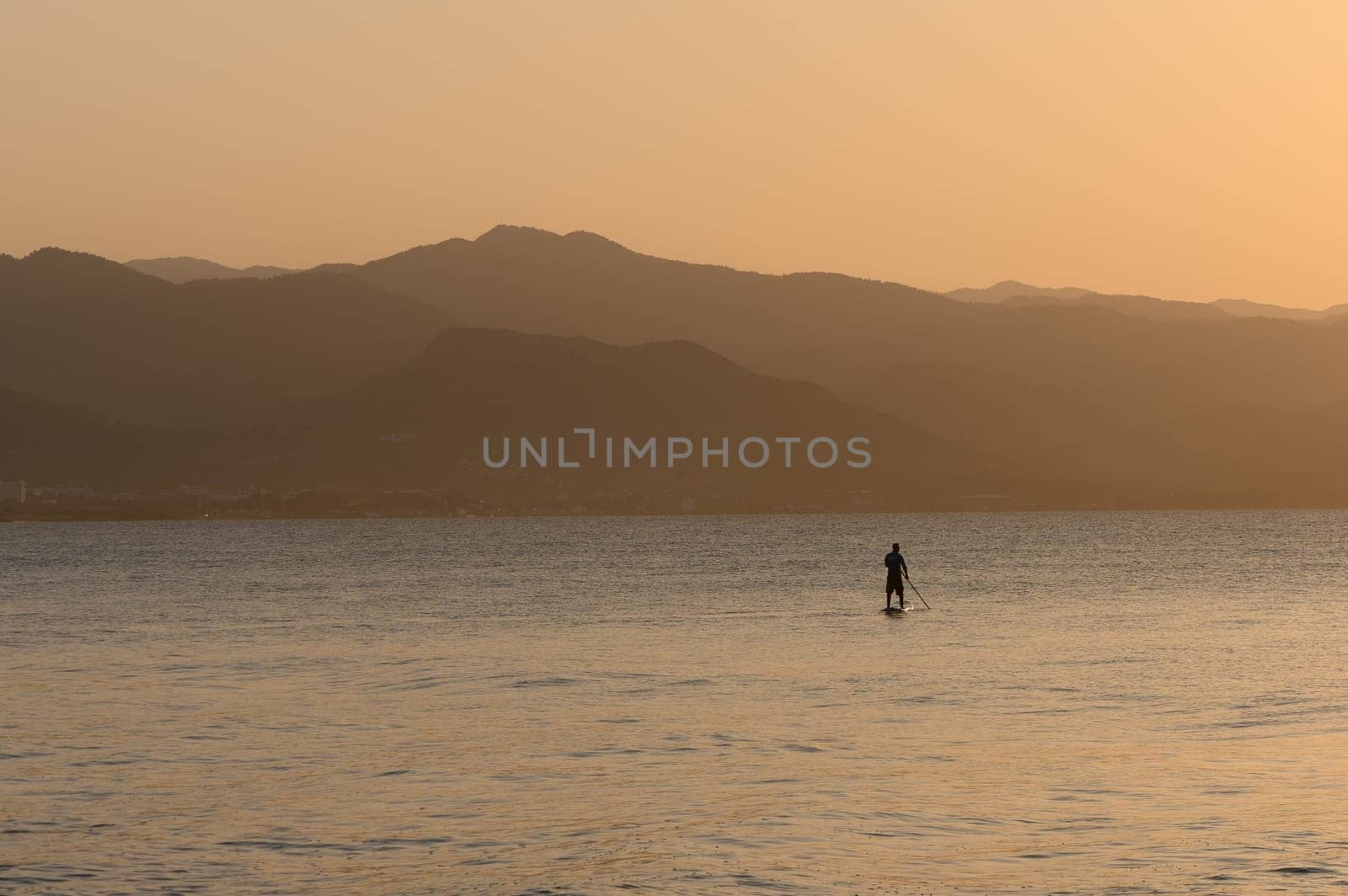 man doing SUP boarding on the Mediterranean Sea 6