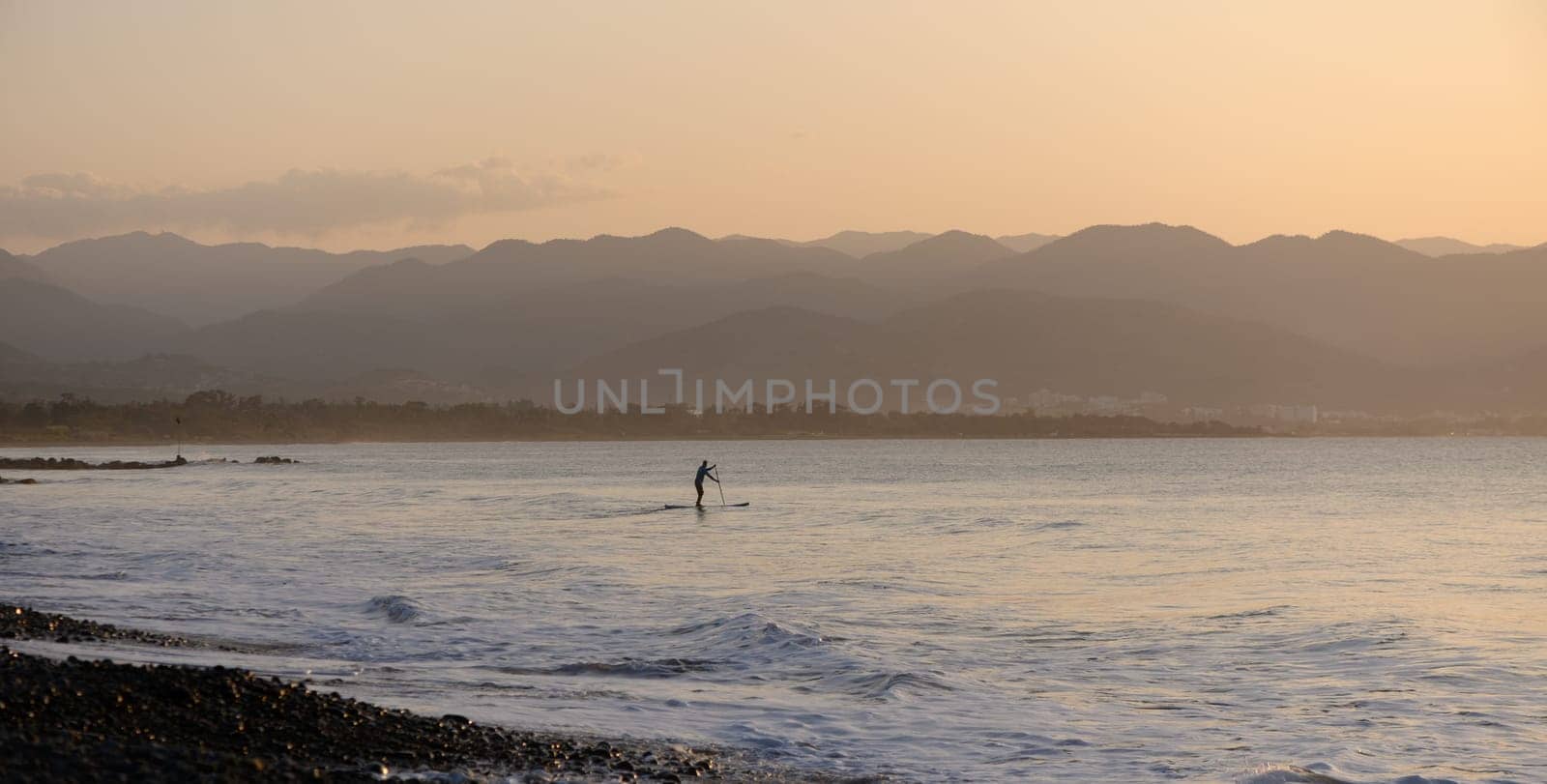 man doing SUP boarding on the Mediterranean Sea 7