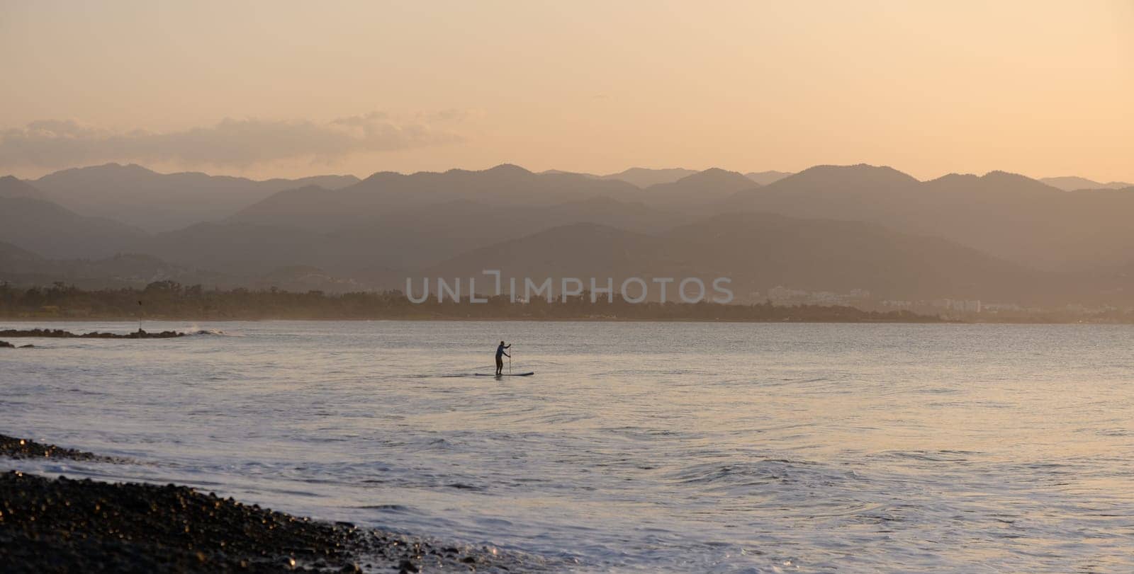 man doing SUP boarding on the Mediterranean Sea 9
