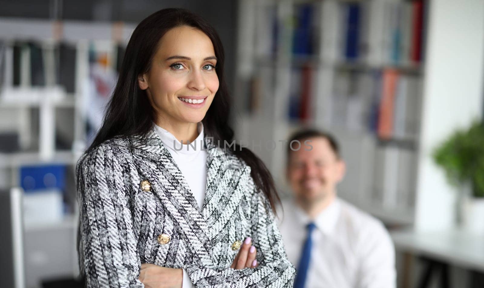 Portrait of cheerful female office worker in luxury suit. Smiling happy brunette manager in cabinet. Copy space in right side. Economy and finance company concept