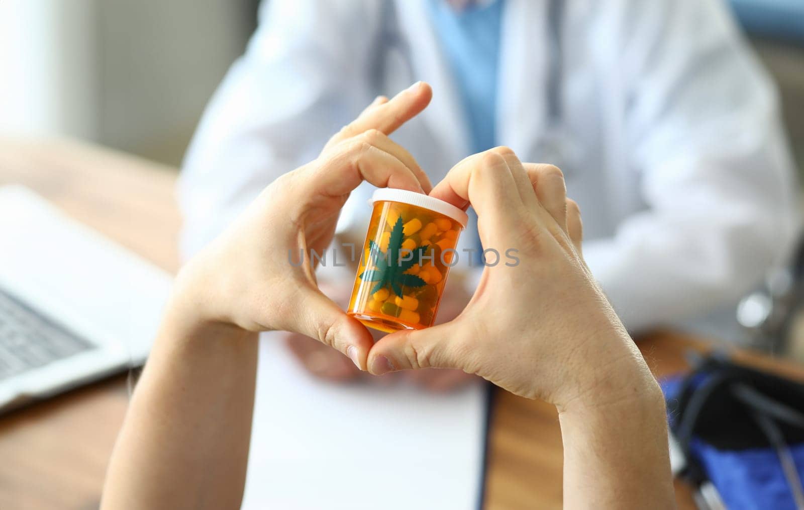 Hands holding capsules in jar with marijuana sign. Hemp drug treatment. Medical cannabis market. Ability to use medicine to get rid alcohol addiction. Use as anesthetic and antirheumatic agent