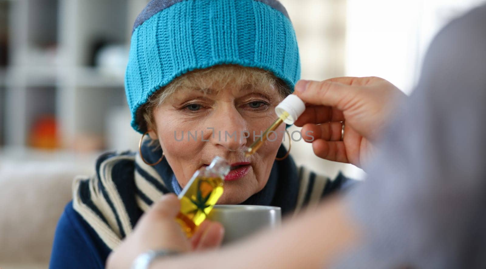 Elderly woman taking medicine by kuprevich