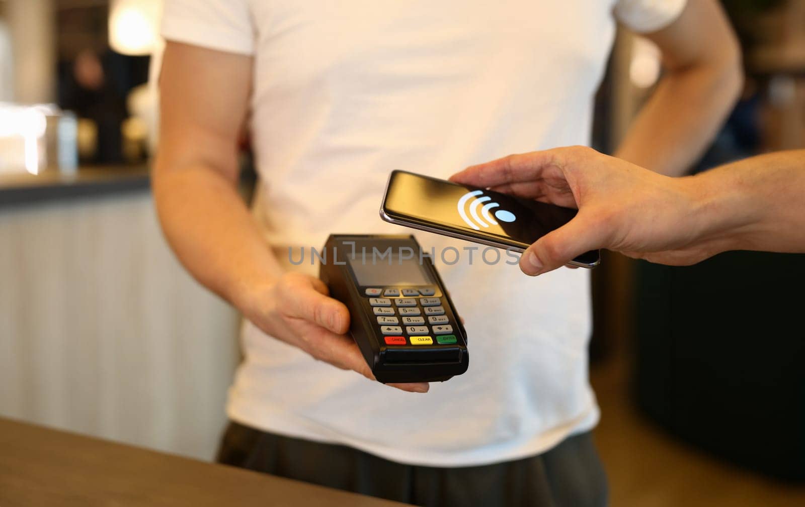 Client paying bill using cellphone by kuprevich