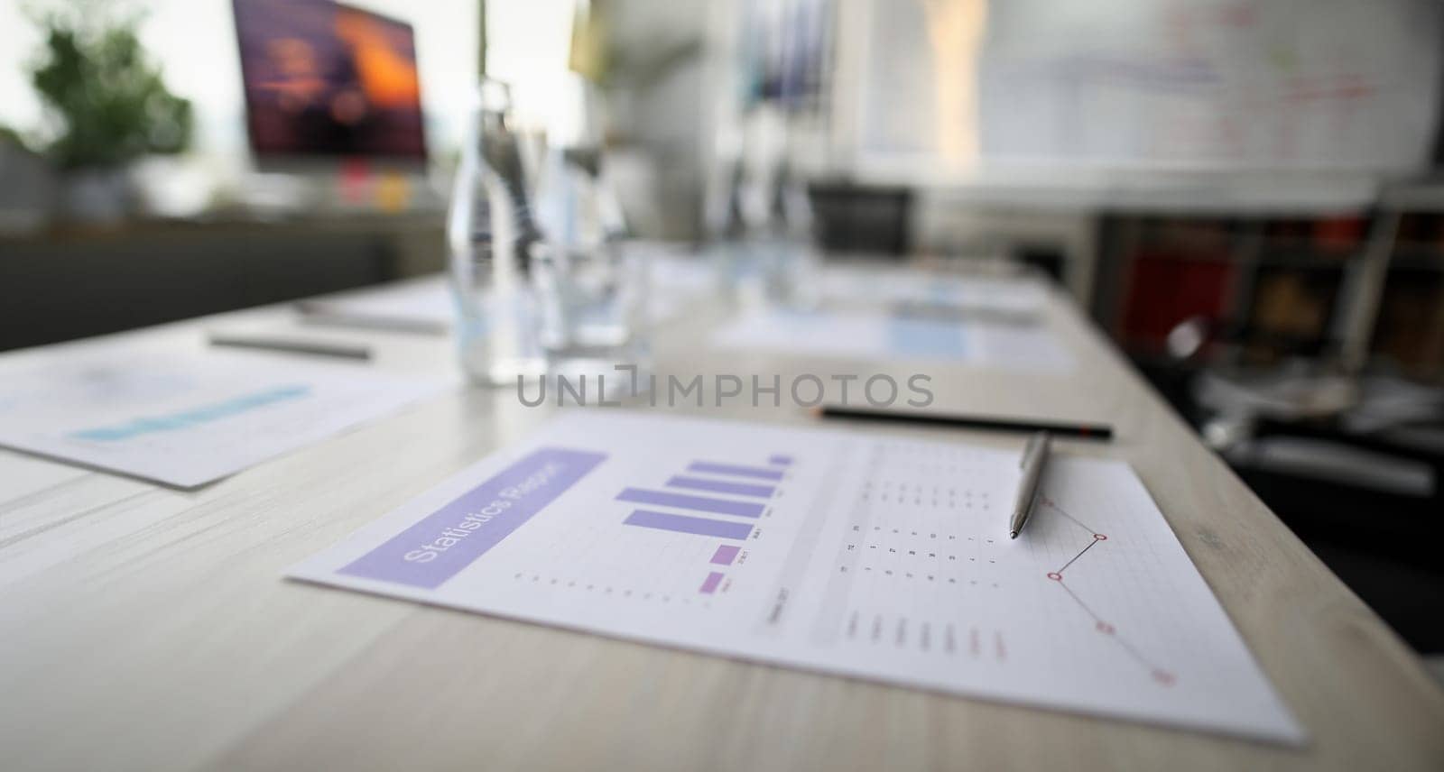 Close-up of statistics paper and silver pen laying on office desktop. Analyzing and gathering statistical data. Growth charts. Business and financial report concept