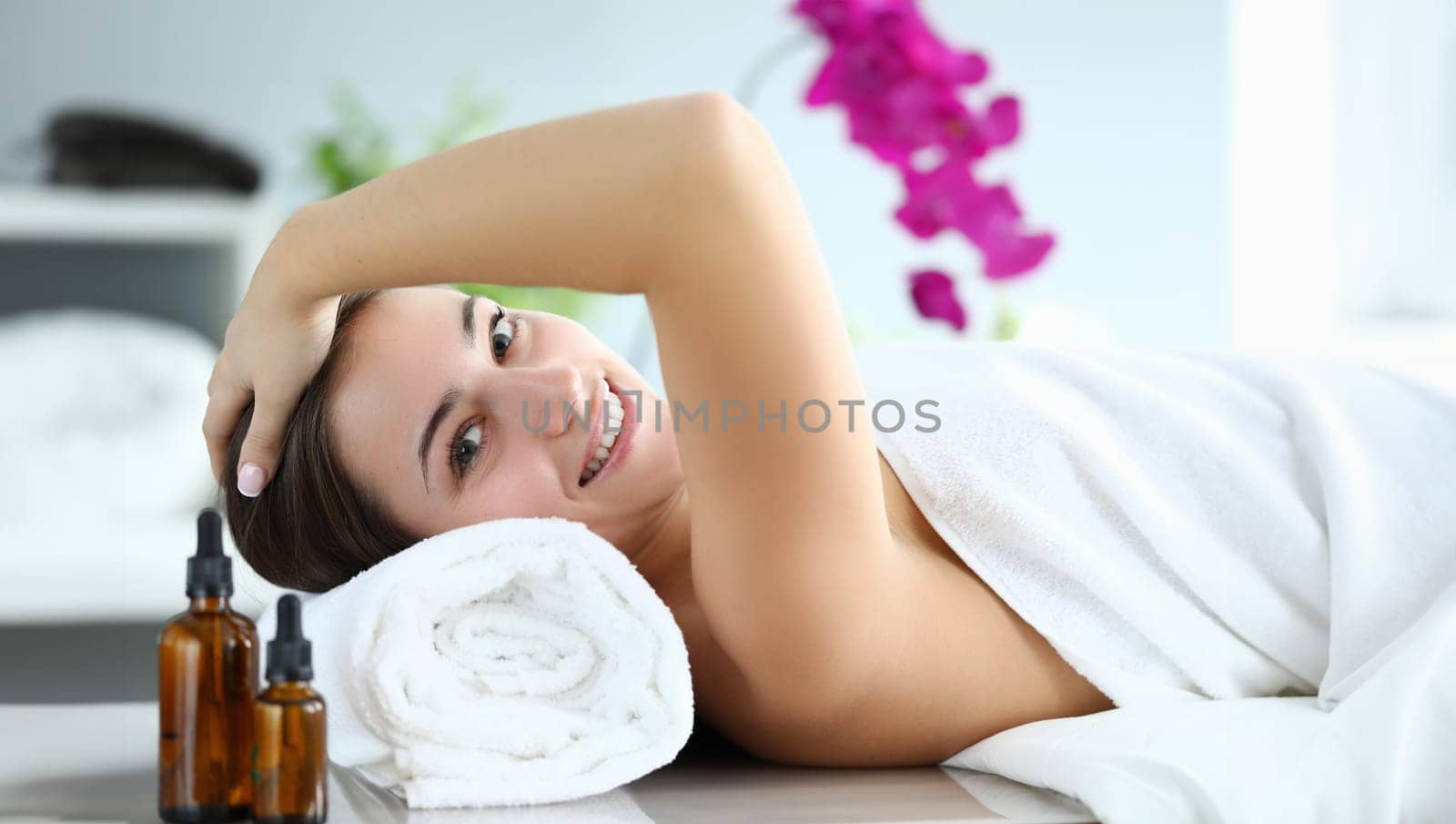 Portrait of wonderful woman looking at happiness and smile. Beautiful businesswoman relaxing on spa treatments. Lady lying in towel. Beauty and relaxation concept