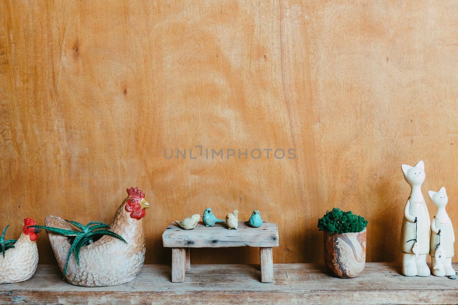 Still life image of Wooden bench and small birds with plant pot on wooden background.