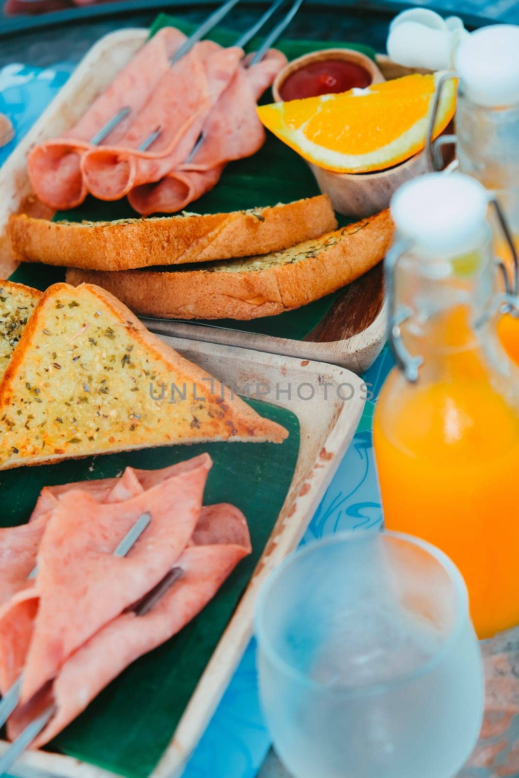 Breakfast with bread, ham, cheese, orange juice and juice