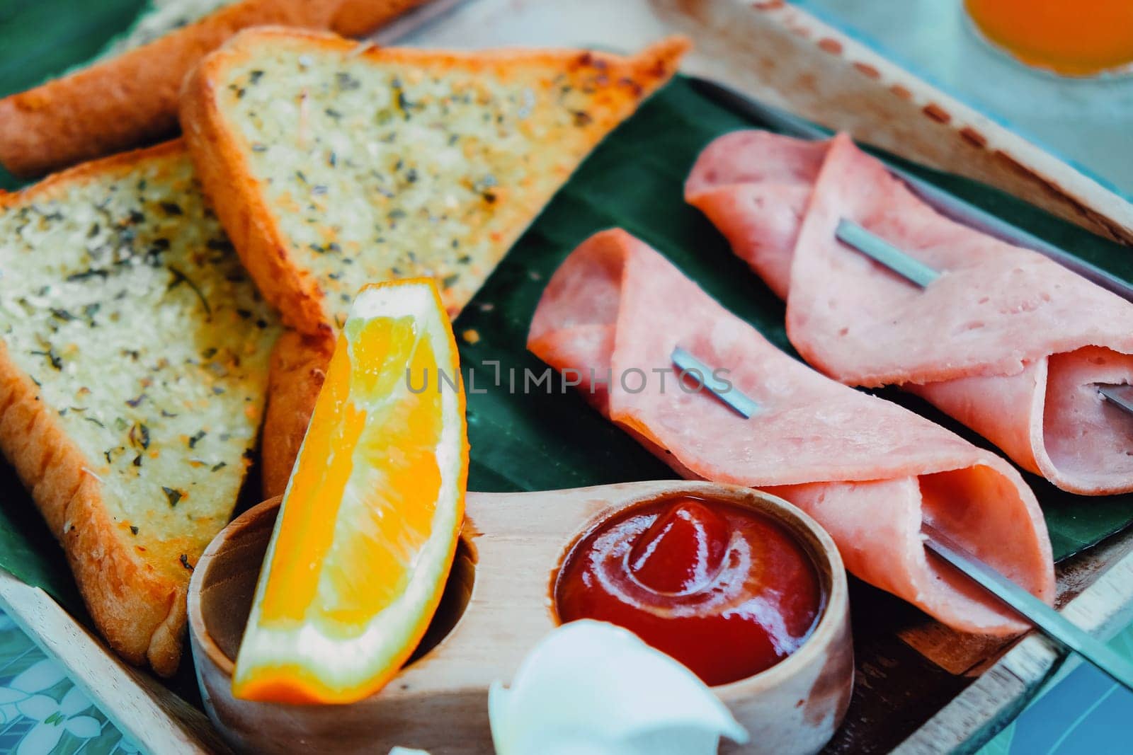 Breakfast with toast bread and ham on wooden tray by ponsulak
