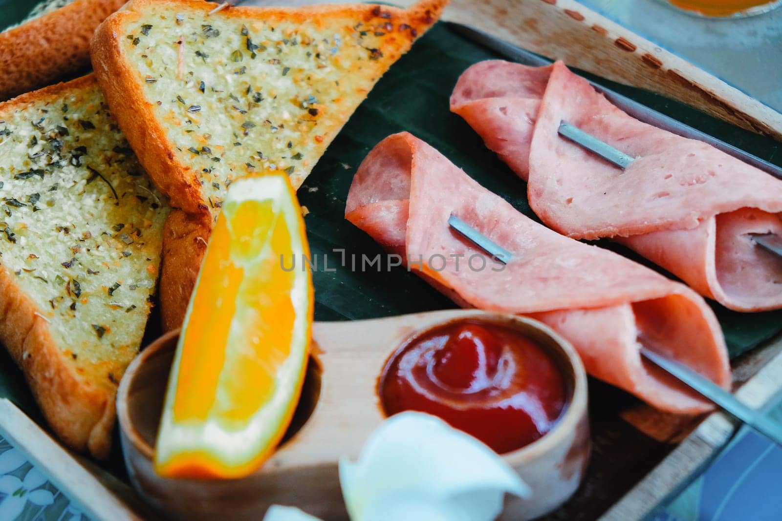 Breakfast with toast bread and ham on wooden tray by ponsulak