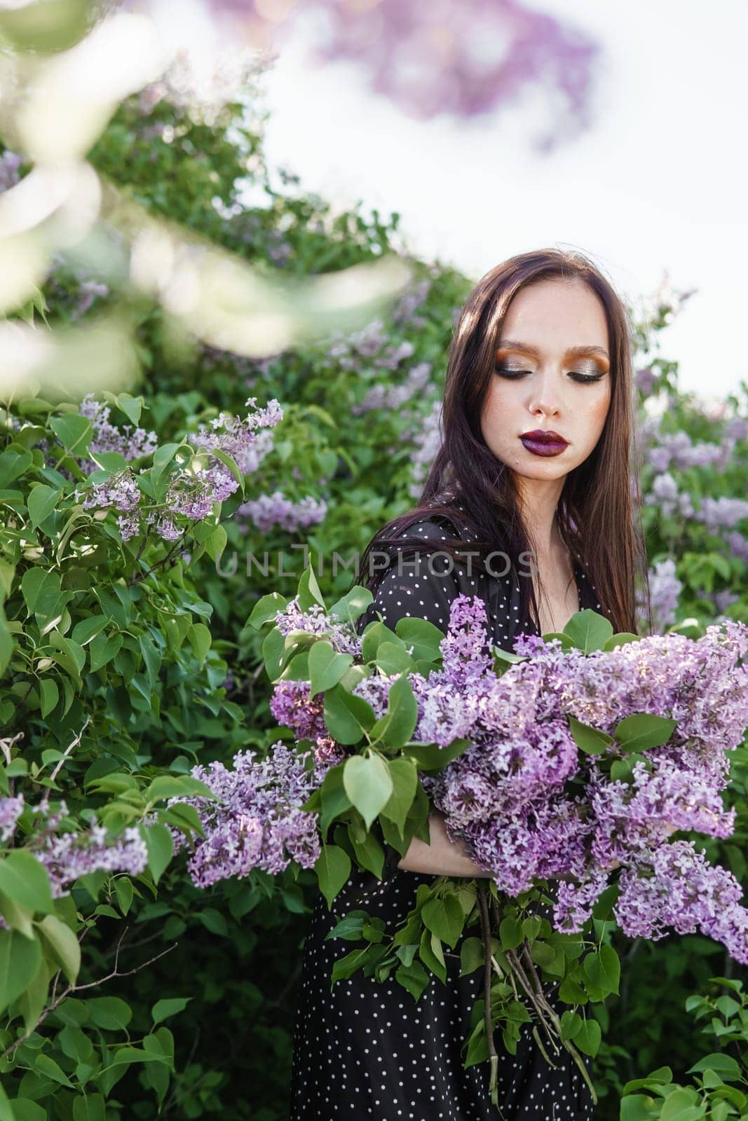 A fashionable girl with dark hair, a spring portrait in lilac tones in summer. Bright professional makeup. by Annu1tochka