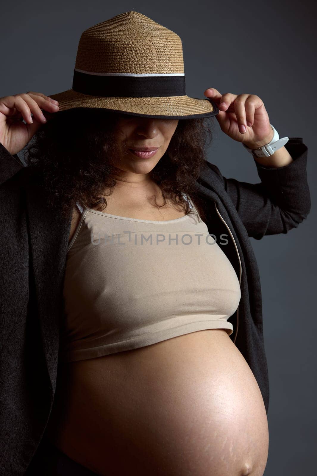 Charming sexy pregnant woman with naked belly, in last trimester of pregnancy, isolated fashion gray studio background. by artgf