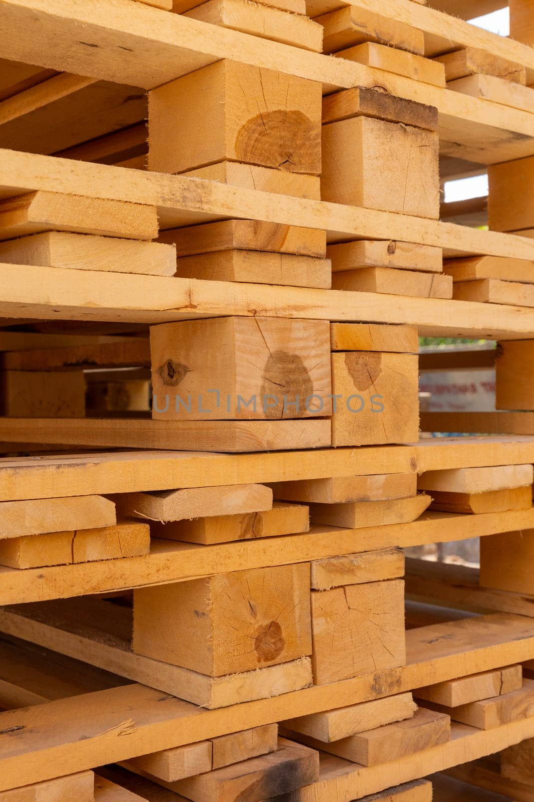 Piles of stacked natural wooden shipping pallets. by BY-_-BY