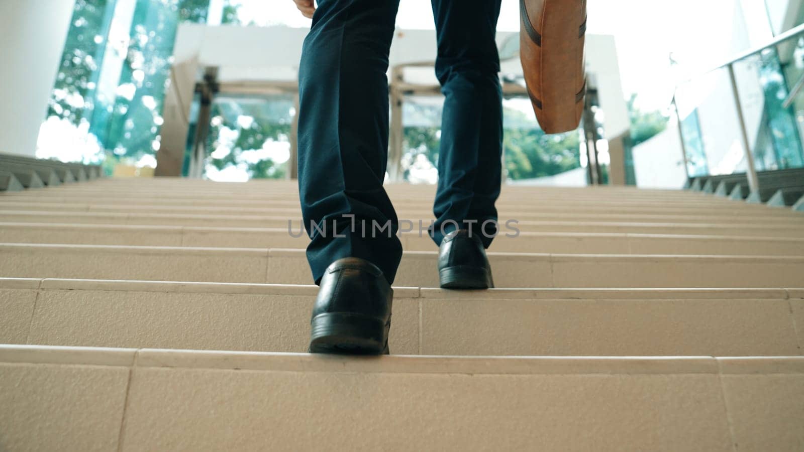 Closeup of business man leg go up the stairs. Traveling. Back view. Exultant. by biancoblue