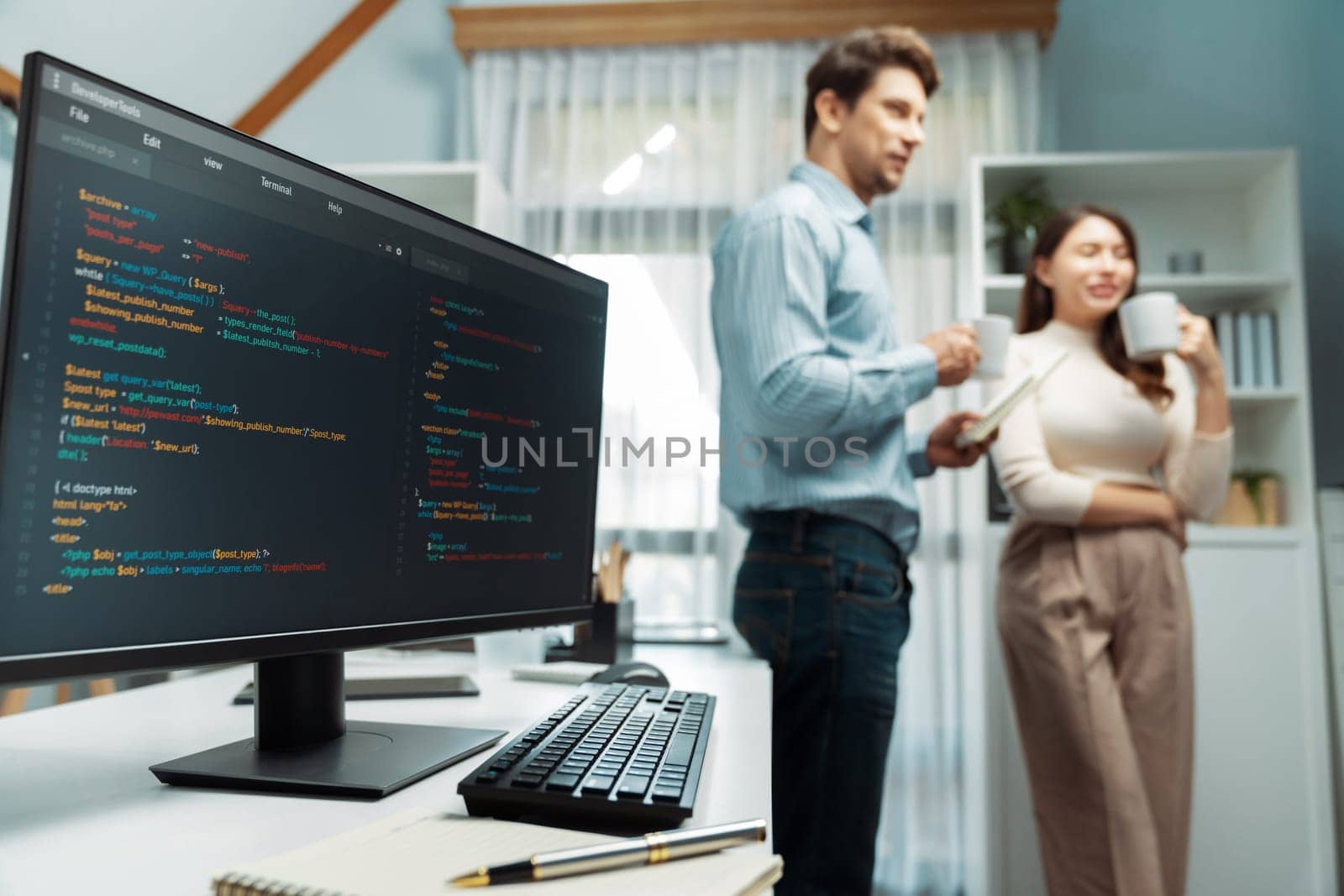 Coding software screens newest creative website on working desk against on developers program drinking coffee to discuss with standing together at corner blurry background with side view. Postulate.