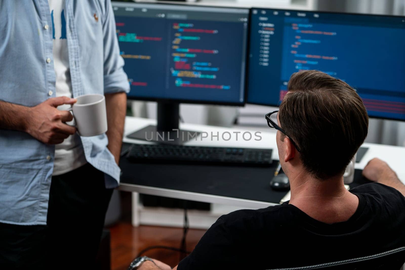 IT developers discussing online software development information on pc screen, creating program coding for latest version application on website. Concept of brainstorming firmware updated. Sellable.