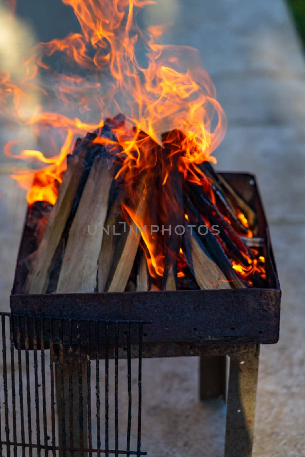 Burning wood chips to form coal. Barbecue preparation, fire before cooking. by vladispas