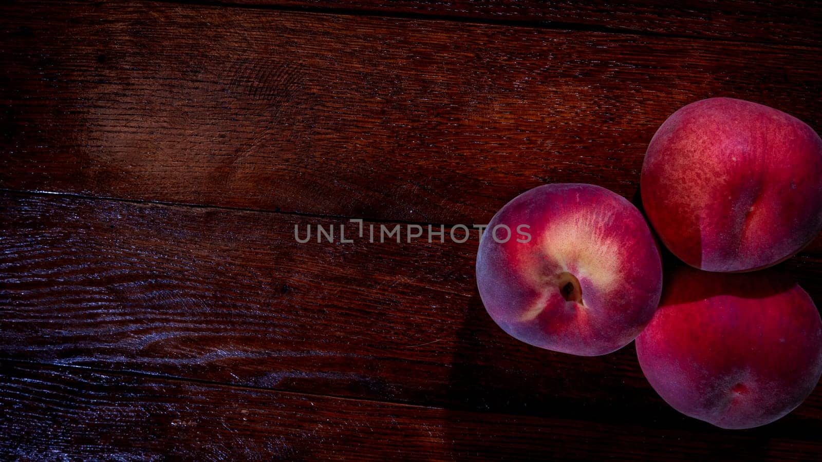 Fresh juicy peaches on rustic wooden table