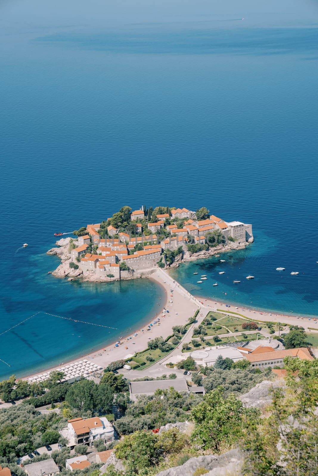 Beach on the isthmus of the island of Sveti Stefan. Montenegro. Top view by Nadtochiy