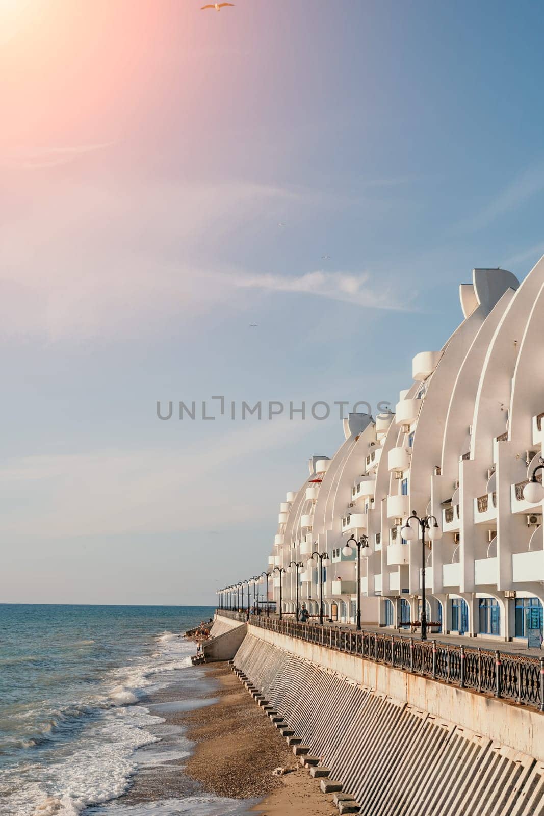 Coastal residential areas with a modern hotel and restaurant complex alongside sandy beaches. Summer holiday vacation and travel concept. by panophotograph