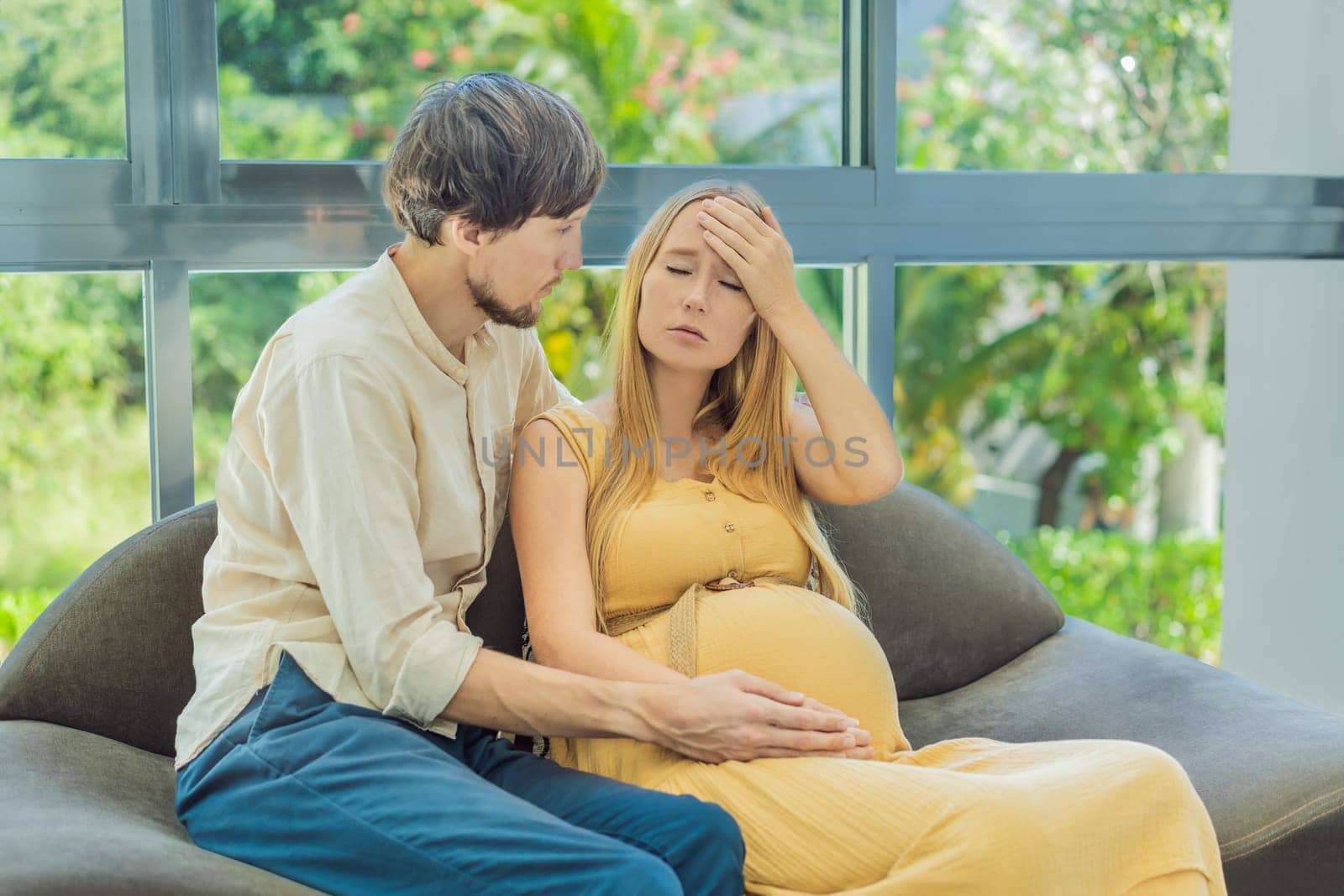 Expectant woman feels unwell, husband comforts and reassures her during a challenging pregnancy by galitskaya