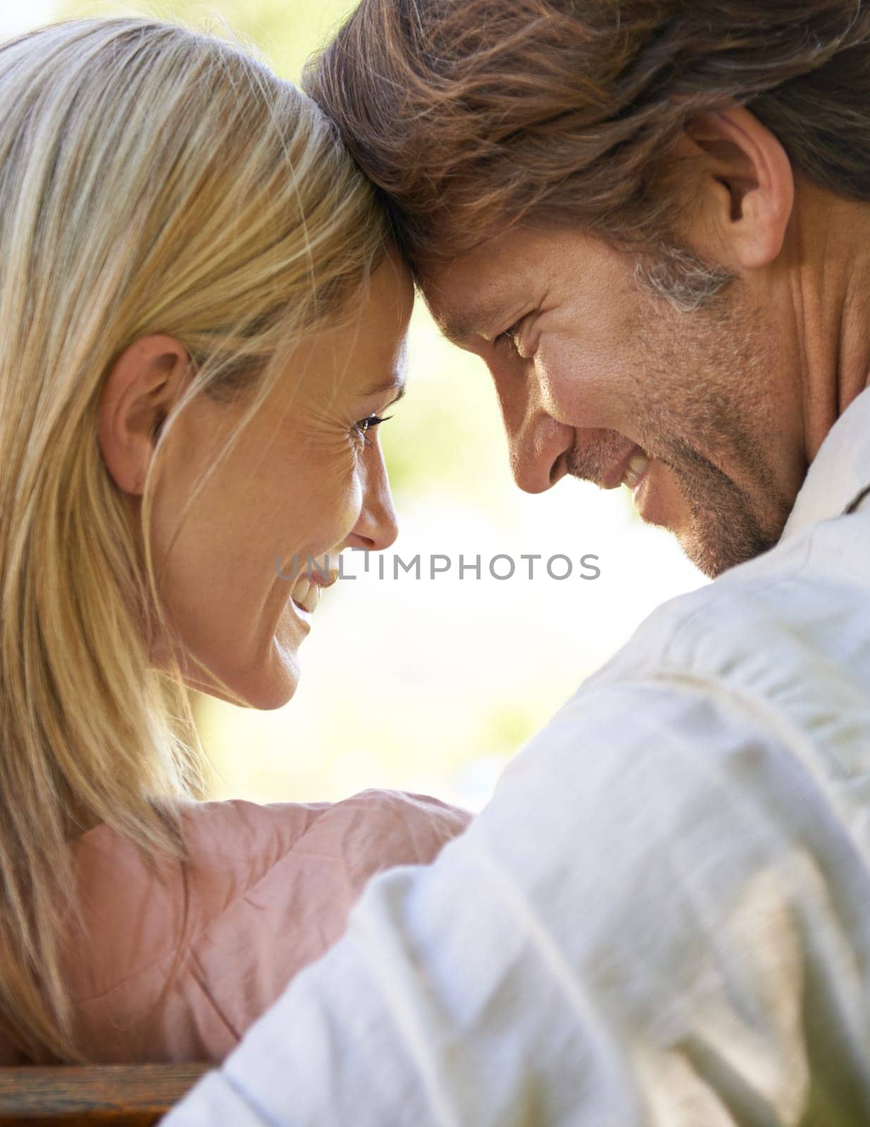 Couple, forehead touch and care in outdoors, love and connection in relationship or security. Mature people, back and date in nature or romance in garden, closeup and vacation or support on holiday.