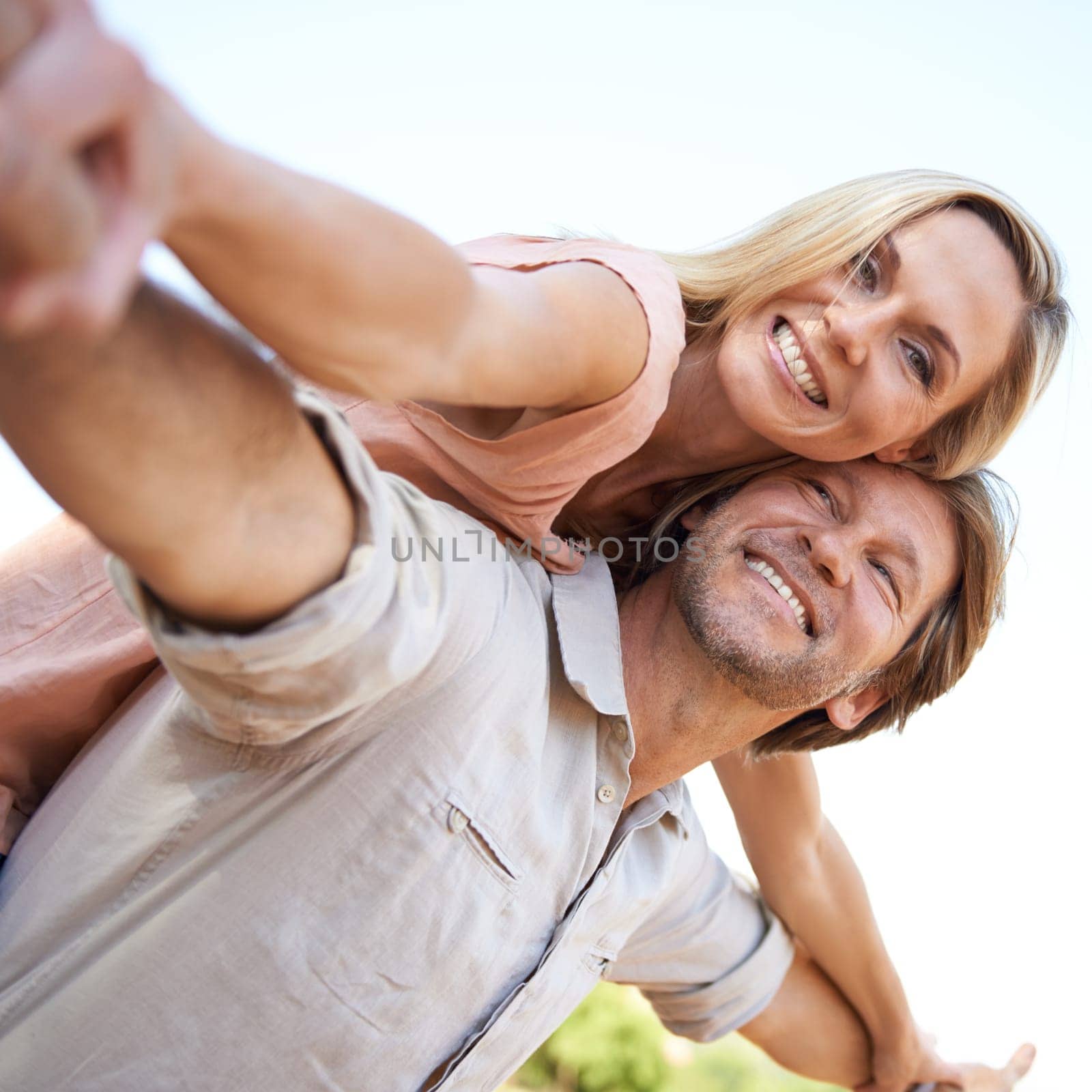 Piggyback, smile and portrait of couple in park hugging for love, care and marriage on vacation. Happy, nature and mature man and woman embrace in garden on holiday or weekend trip for romantic date