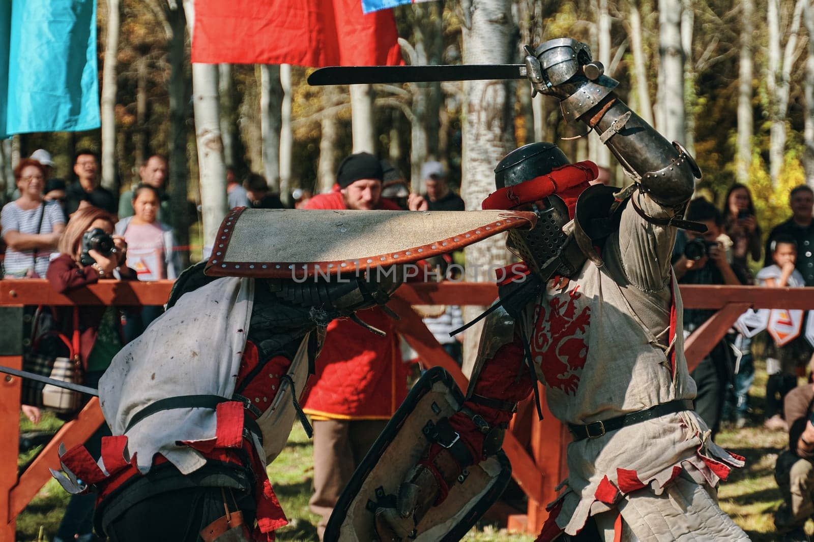 Imitation of medieval jousting. The battle of two knights with swords. Reconstruction of the historical tournament. Bishkek, Kyrgyzstan - October 13, 2019