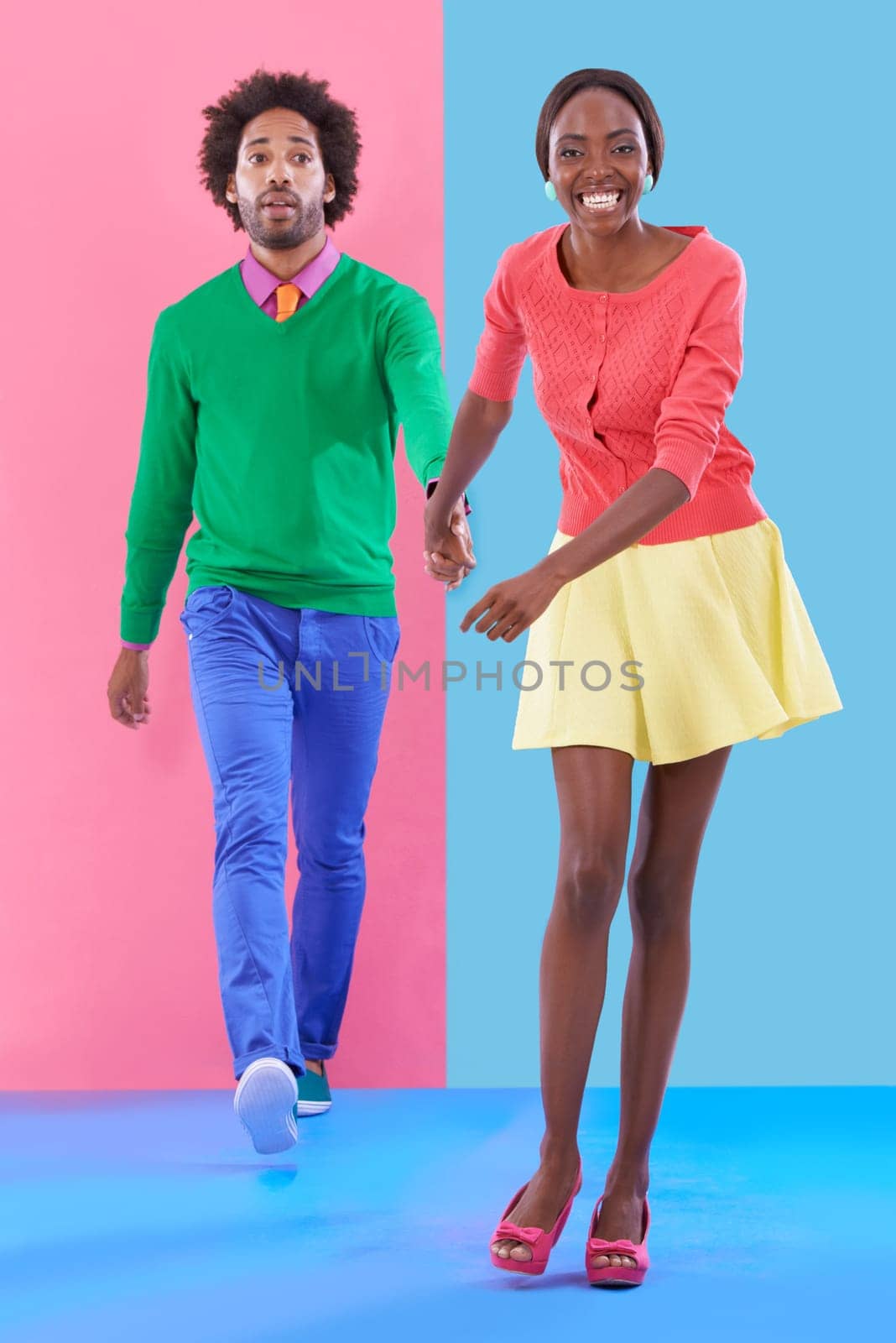 Couple, walk and holding hands with fashion in portrait, studio or creative aesthetic on background. Excited, woman and man together with colorful retro style, unique clothes or leading with trust.
