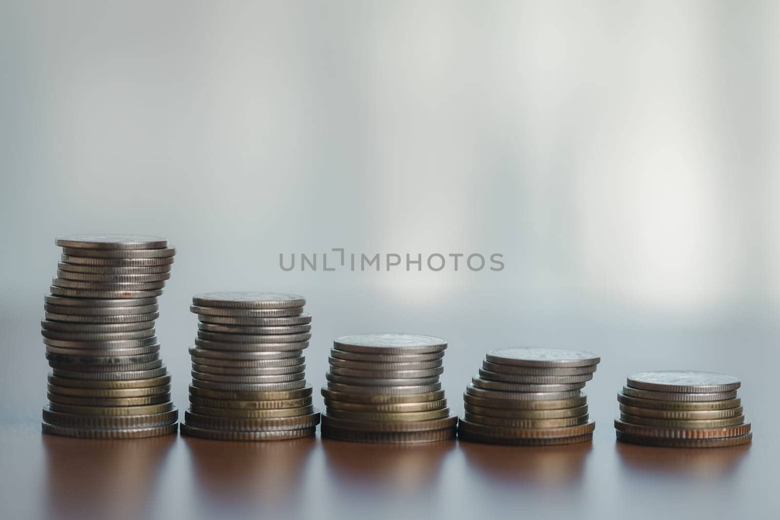 Table with stacked coins, symbolizing wealth, finance, and success in business and banking money, currency, and cash contribute to a growing pile, reflecting investment, savings, and financial growth