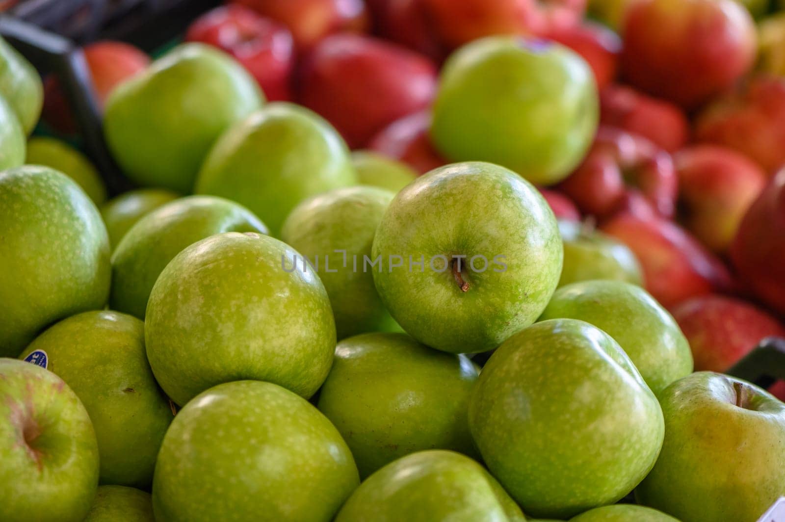 Green and red apples for sale in a market