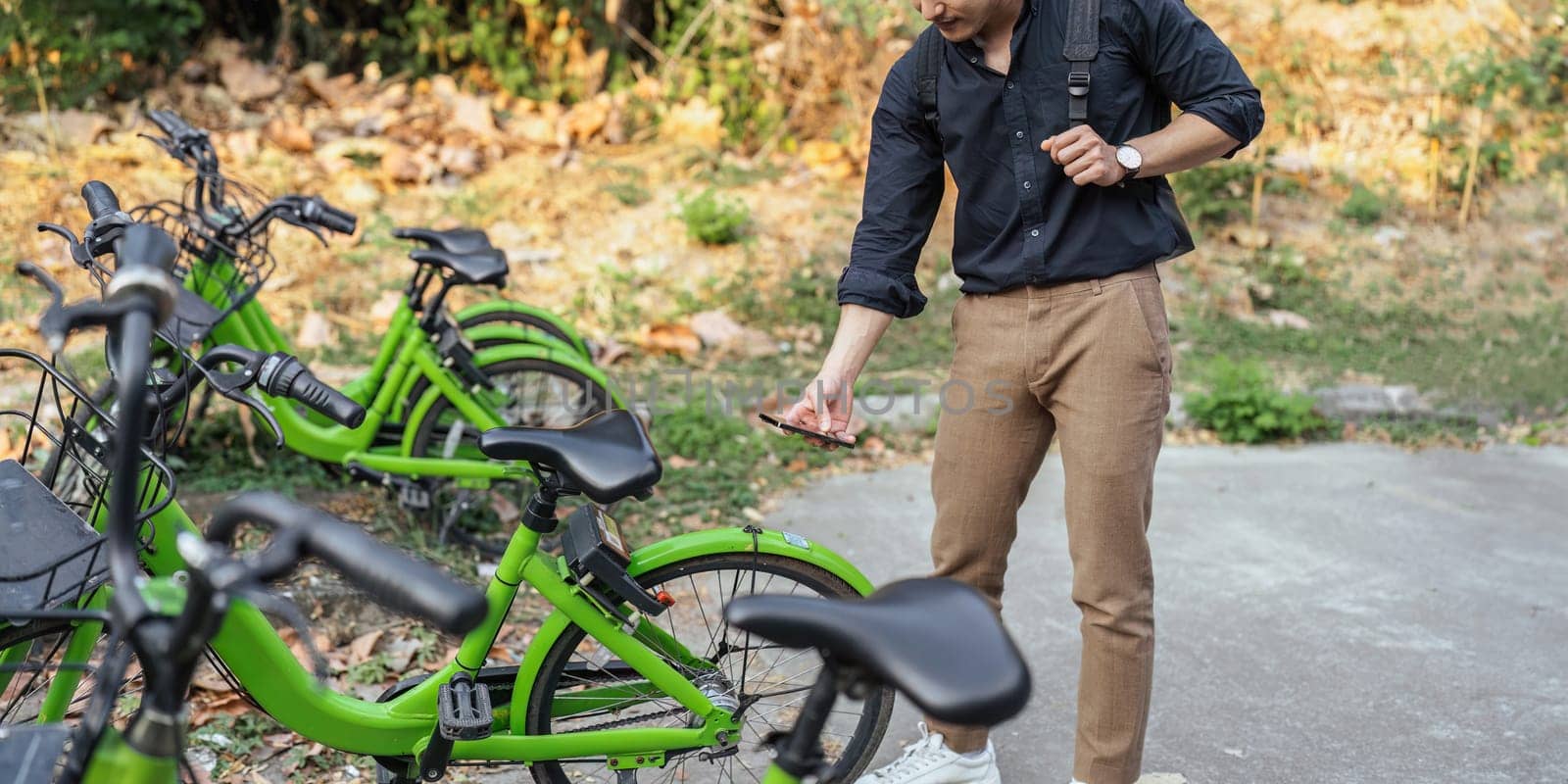 business man holding mobile using bike rental digital phone app scanning qr code to rent electric bicycle in city by itchaznong