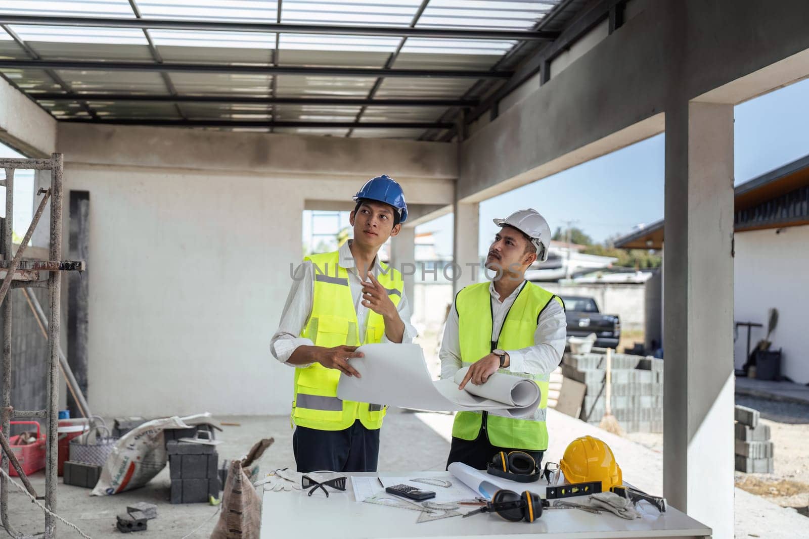 Two Specialists Inspect Commercial, Industrial Building Construction Site. Real Estate Project with Civil Engineer.