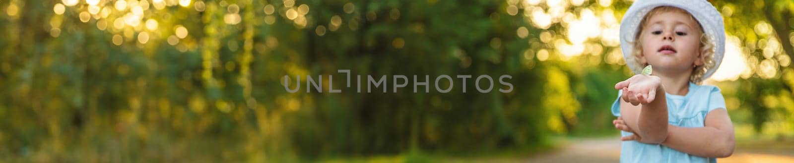 A child catches a butterfly in nature. Selective focus. Nature.