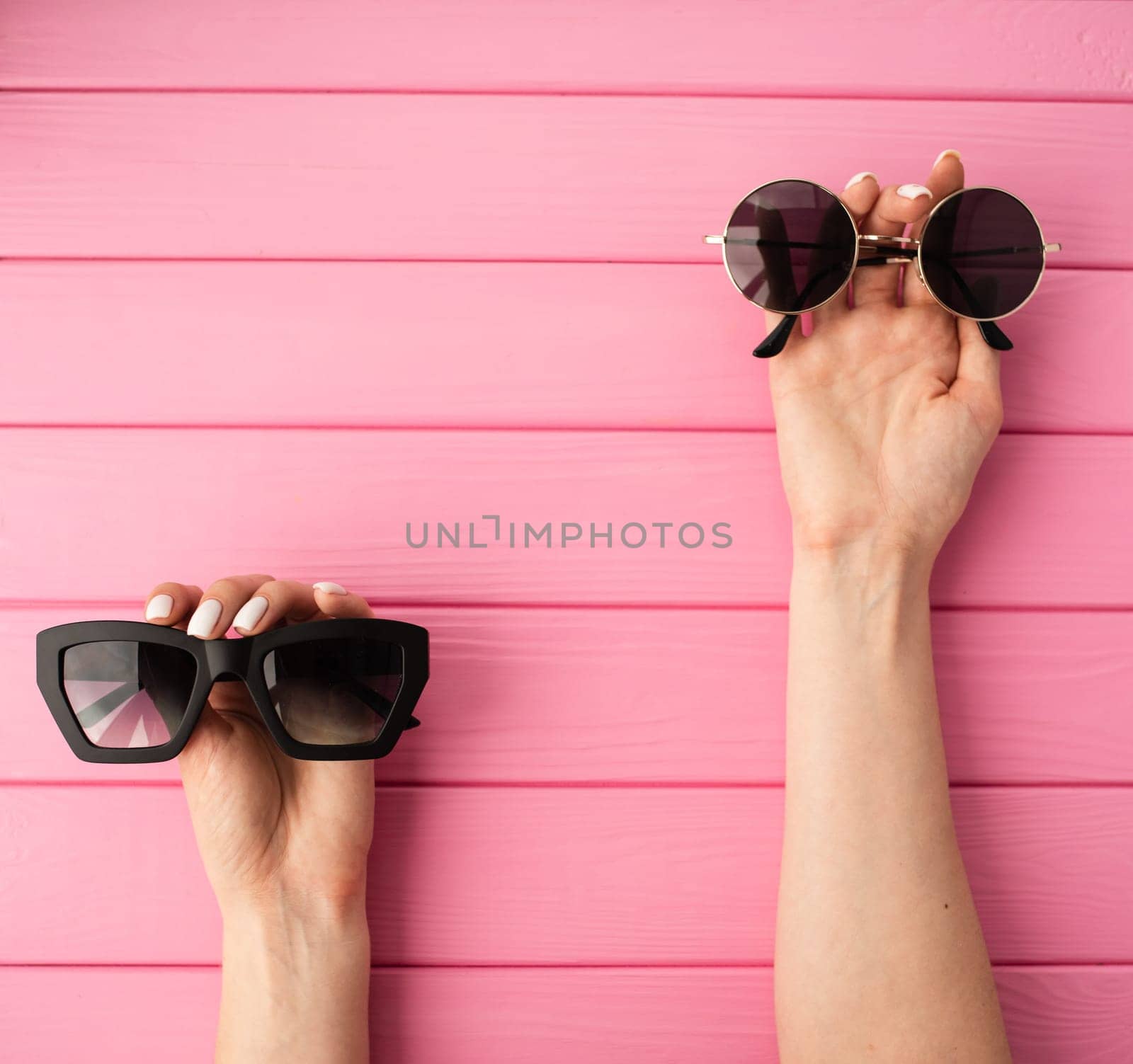 Summer abstract background mockup template woman hands hold Couple sunglasses fashionable by AndriiDrachuk