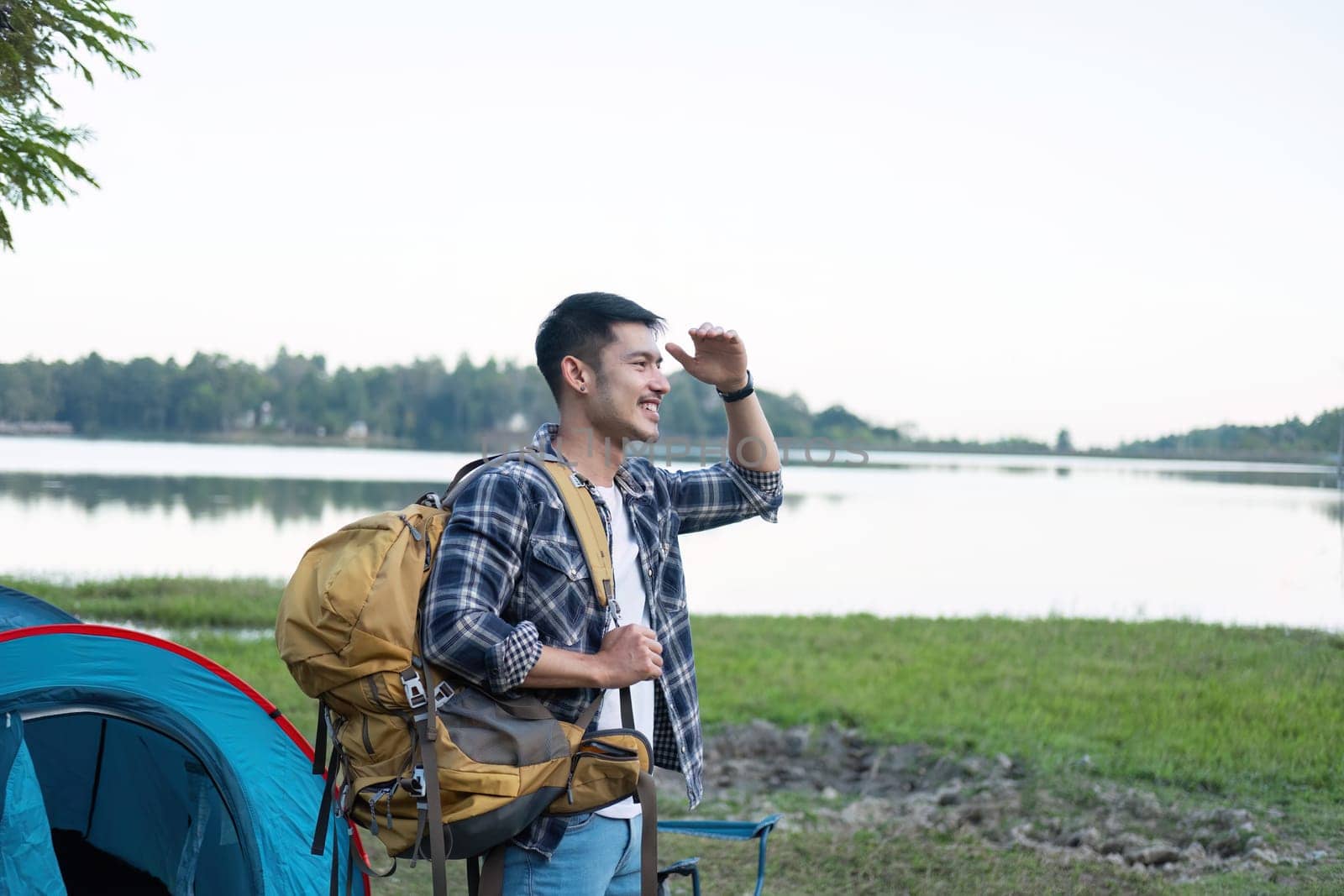 Asian tourist smiling happily Backpacker, hiking trips, outdoor activities on vacation..