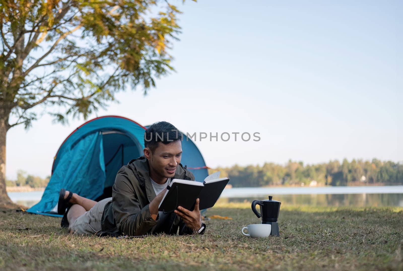 Asian tourists happily spend their free time camping, relaxing, and doing outdoor activities..