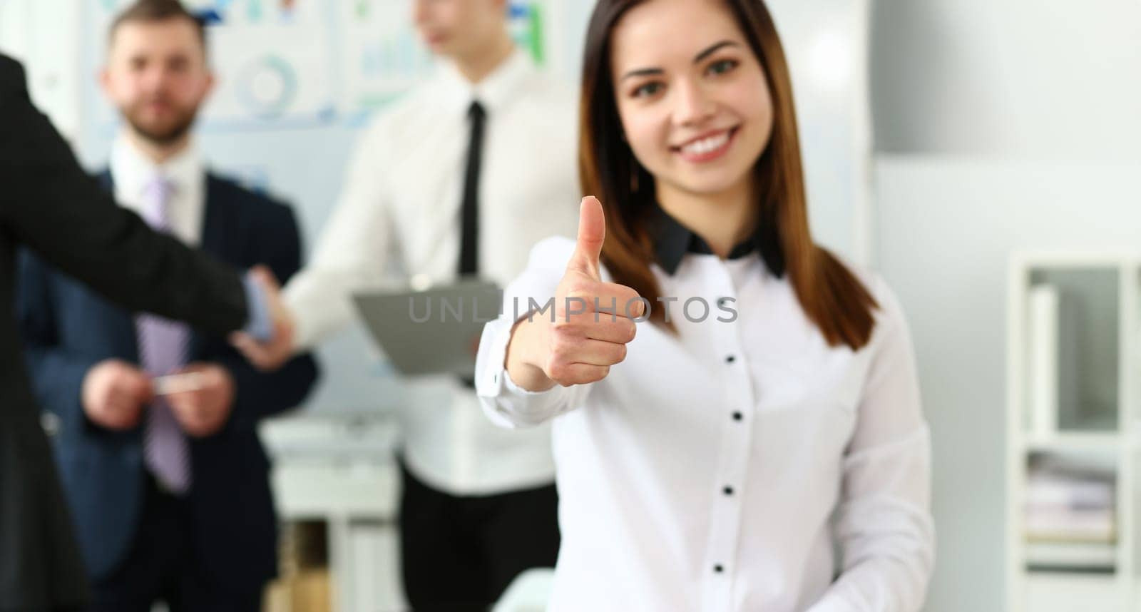 Woman showing confirm symbol during conference in office as high level and quality of product or mediation gratitude concept