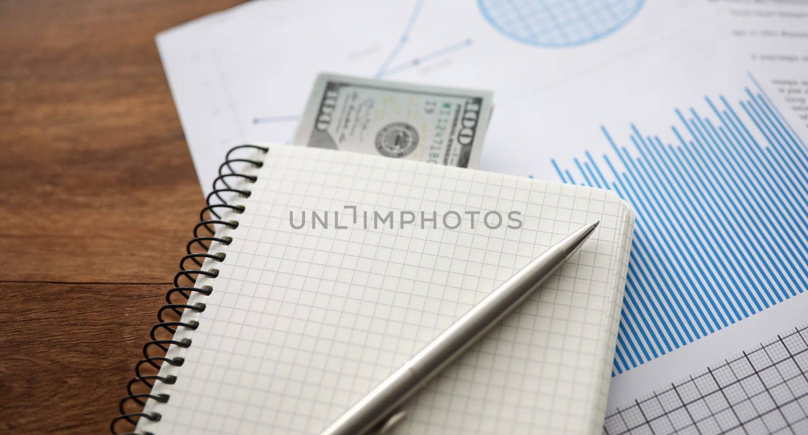 Close-up view of paper and banknote. Financial document with graphs and diagrams. Paperwork in office. Planning management strategy and finance accountant concept. Copy space