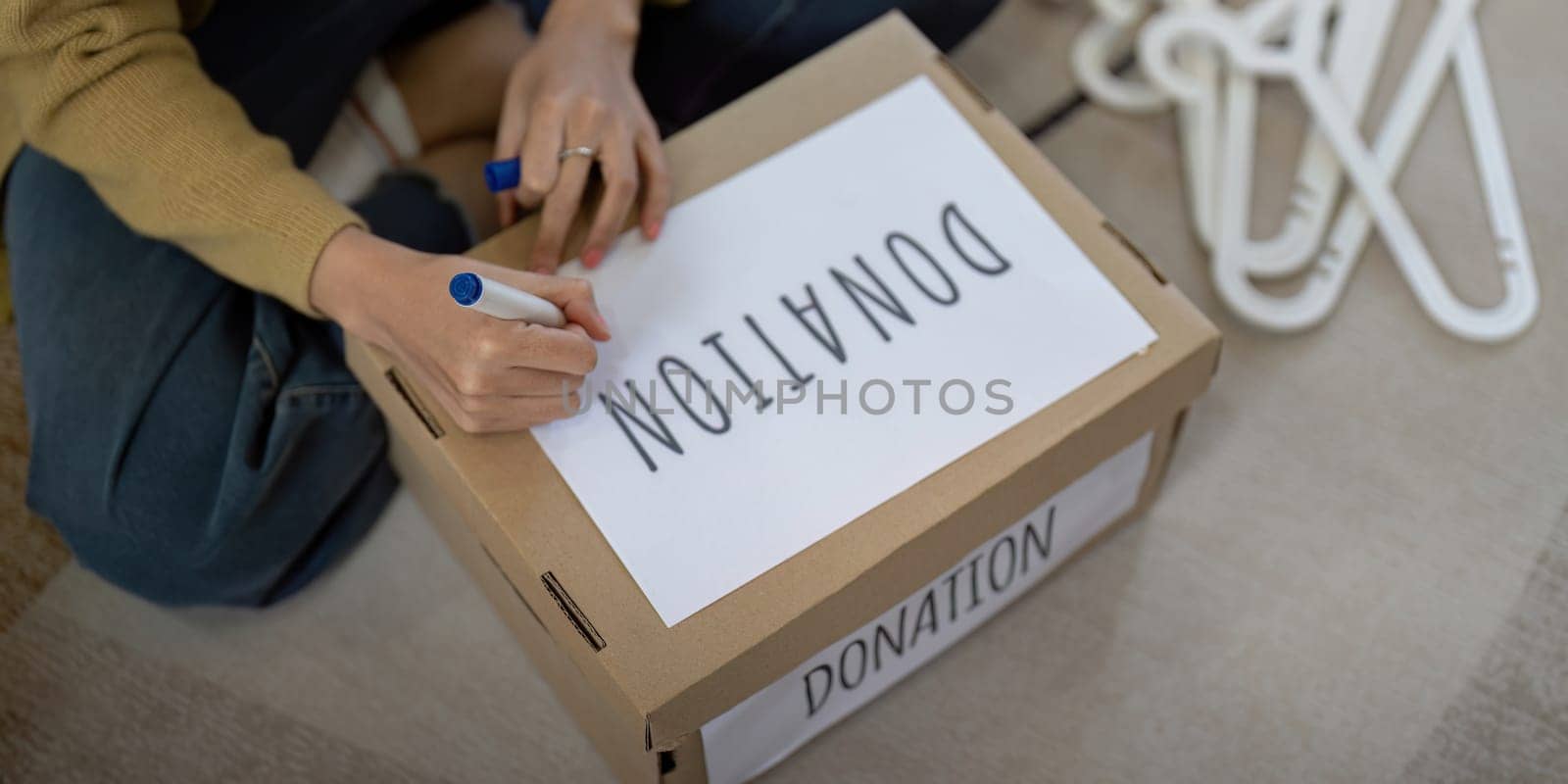 Woman asian preparing a delivery box with her used clothes, Donation and recycling concept.