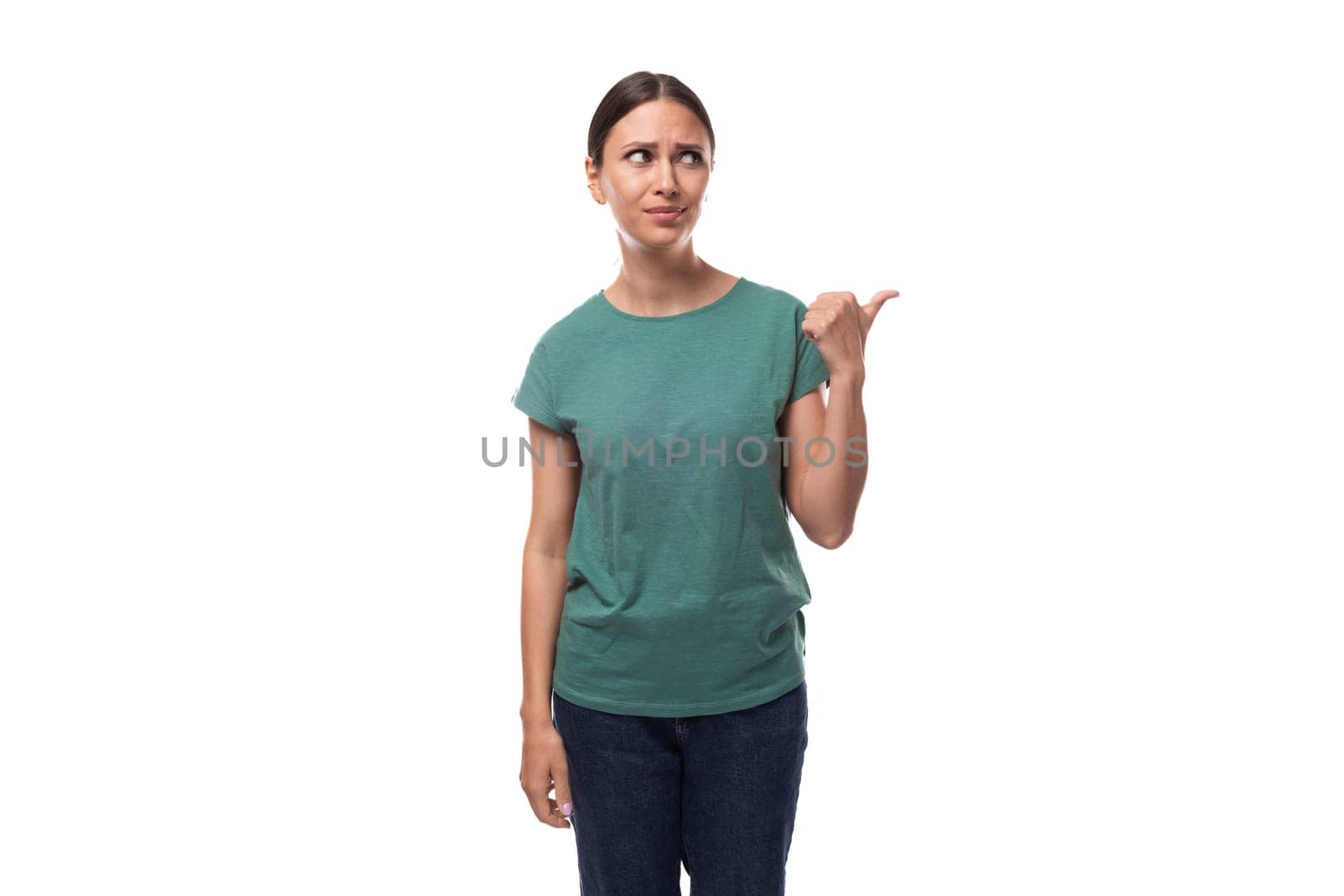 well-groomed slender young brunette woman dressed in a green t-shirt surprised by the news by TRMK