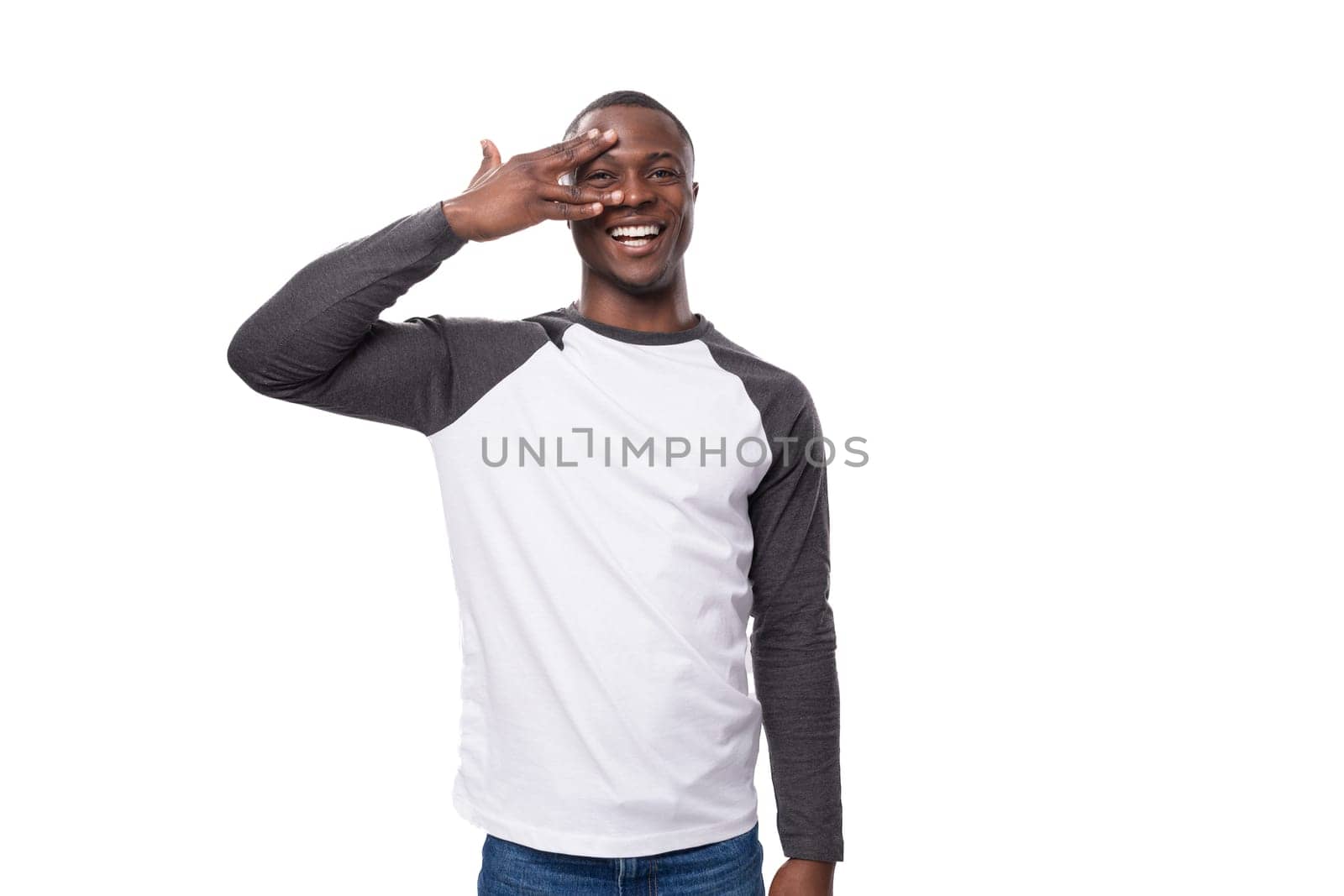 a young American guy with a short haircut is actively gesturing on a white background with copy space.