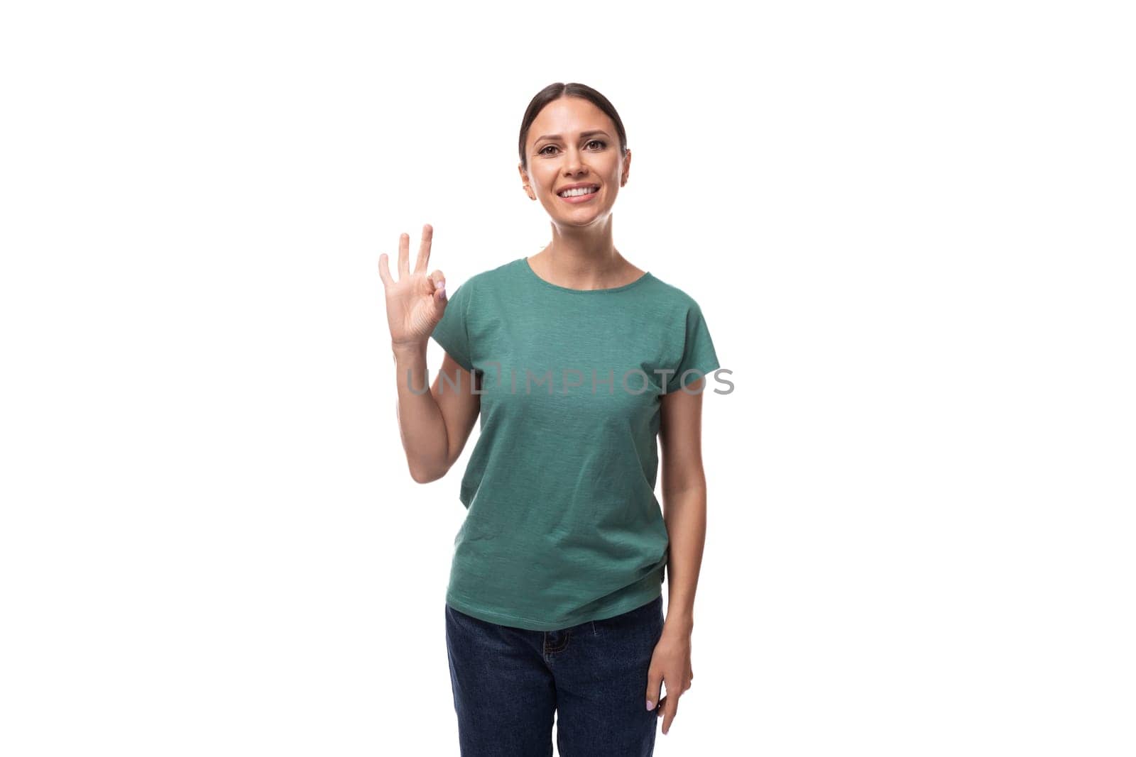 young woman in t-shirt and jeans showing ok and approval gesture by TRMK
