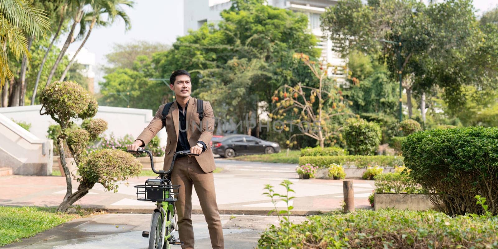 The businessman eco friendly transportation, cycling through the city avenues to go to work. sustainable lifestyle concept.