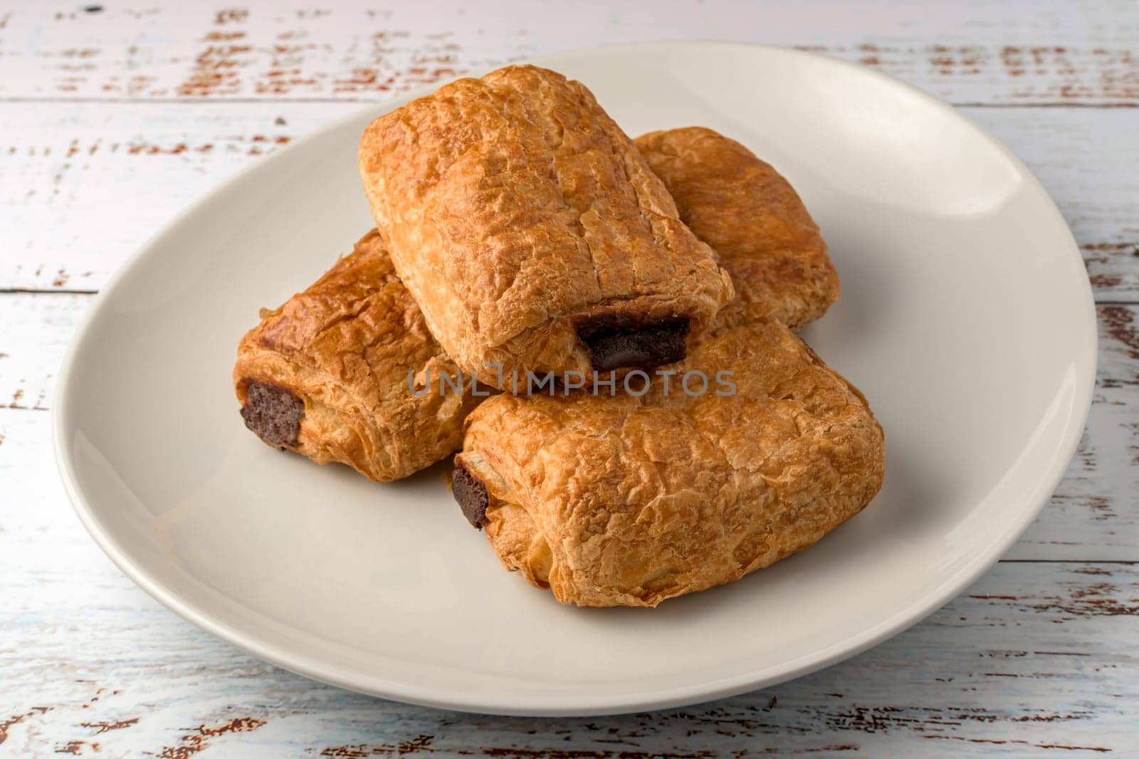 freshly baked croissants on wooden cutting board, top view,